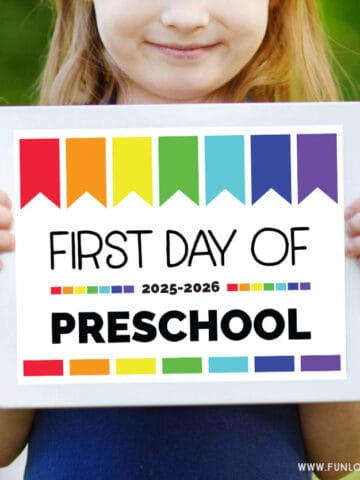 girl holding first day of preschool sign