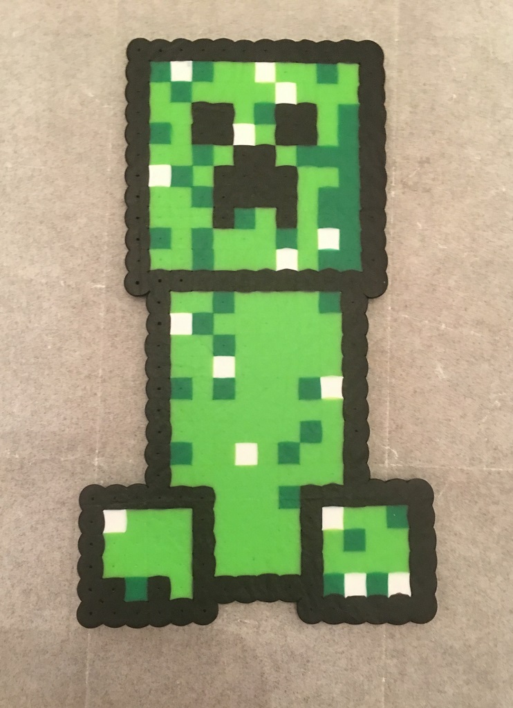 Followed an old perler bead pattern I made to make this glow in the dark  Creeper! Stands 5 inches tall, made entirely of beads and one metal clip  that allows the head